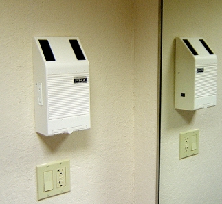 Bathroom installation of Wall Mounted Active Air Purifier w/ reflection in mirror.